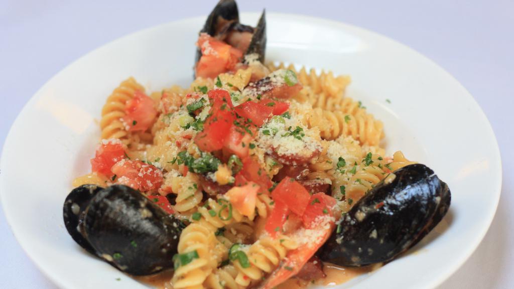 Pasta Orleans · Sautéed shrimp, crawfish, mussels, and andouille sausage with fusilli pasta in a spicy red pepper-garlic cream.