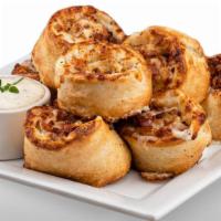 Cheezee Bacon Rolls · Rich and buttery bacon rolls made with our creamy signature white garlic sauce and filled wi...
