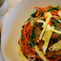 Japchae · Stir-fried glass noodles with beef and vegetables.