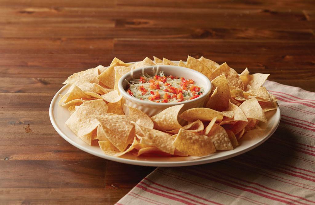 Spinach & Cheese Dip · Spinach and artichokes blended with creamy cheese and served hot with fresh tortilla chips.