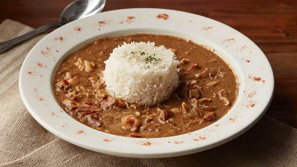 New Orleans Gumbo  · A New Orleans style gumbo with traditional savory roux broth, shrimp, chicken and andouille sausage. Served with steamed white rice.