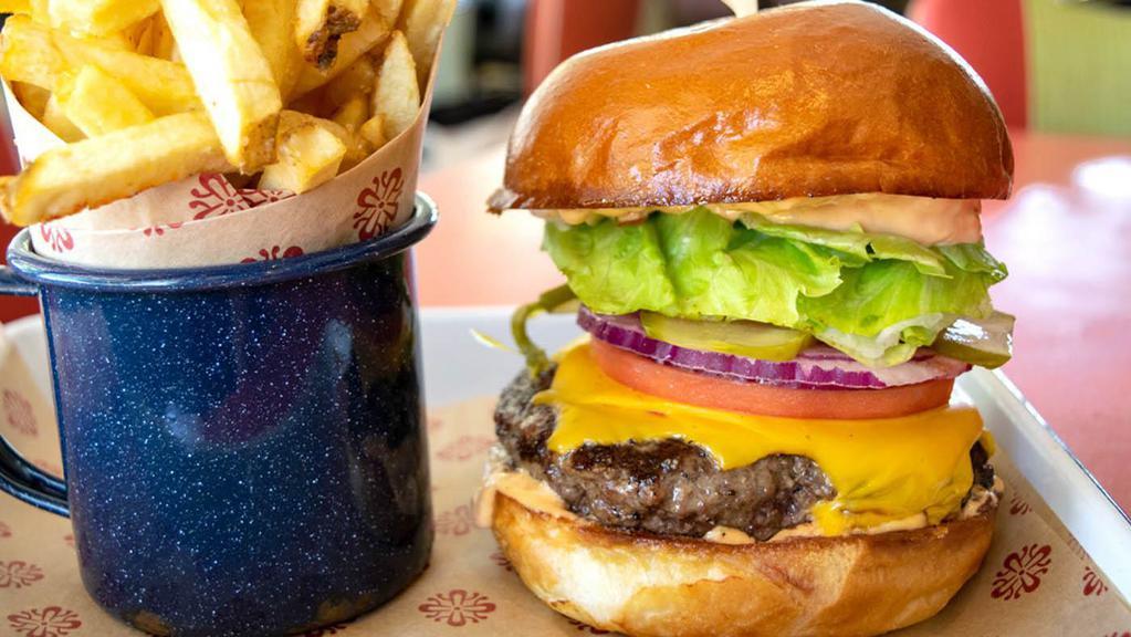 Lucille'S All American Burger · Certified Angus beef, flame-grilled and topped with melted American cheese, tomato, pickles, lettuce, sweet red onions and thousand island dressing on a soft brioche bun.