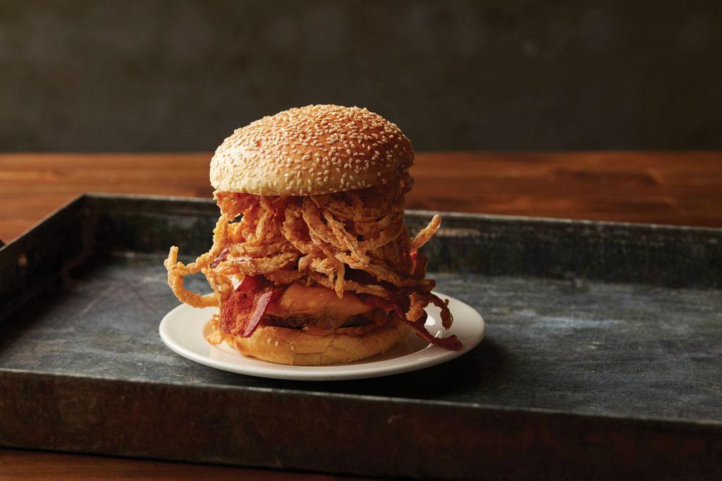 Smokehouse Bbq Bacon Burger · Certified Angus beef, flame-grilled and basted with our original BBQ sauce and topped with smoked bacon, melted cheddar cheese and onion straws with BBQ ranch dressing on a sesame seed bun.
