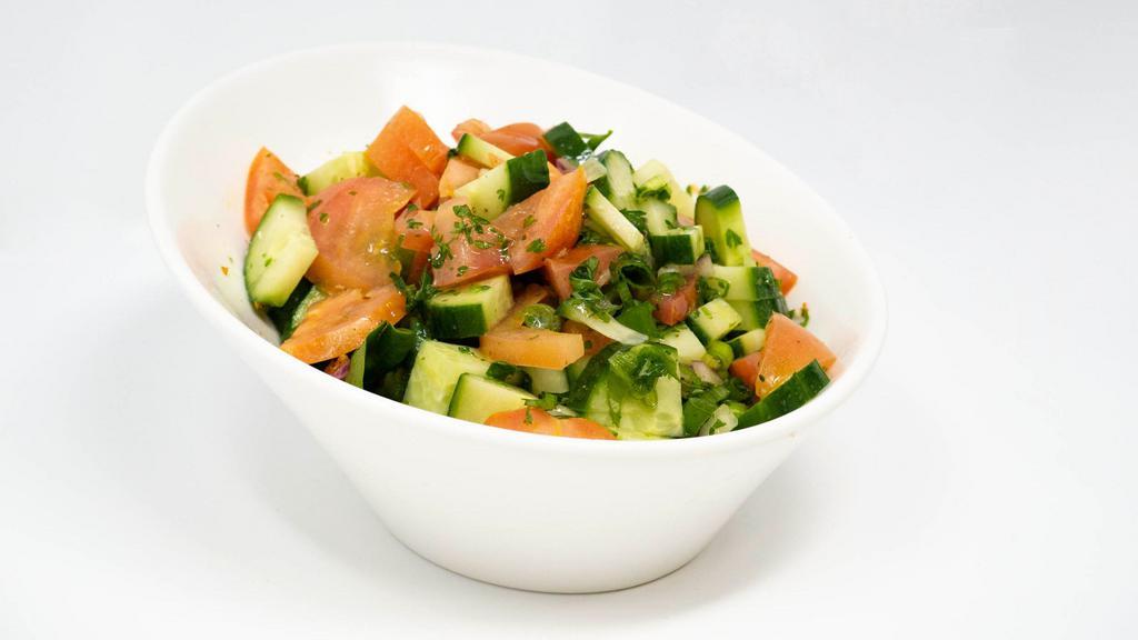 Turk Salatasi · Gluten-free. Tomatoes, cucumbers, onions and parsley served with lemon and olive oil-vinaigrette.