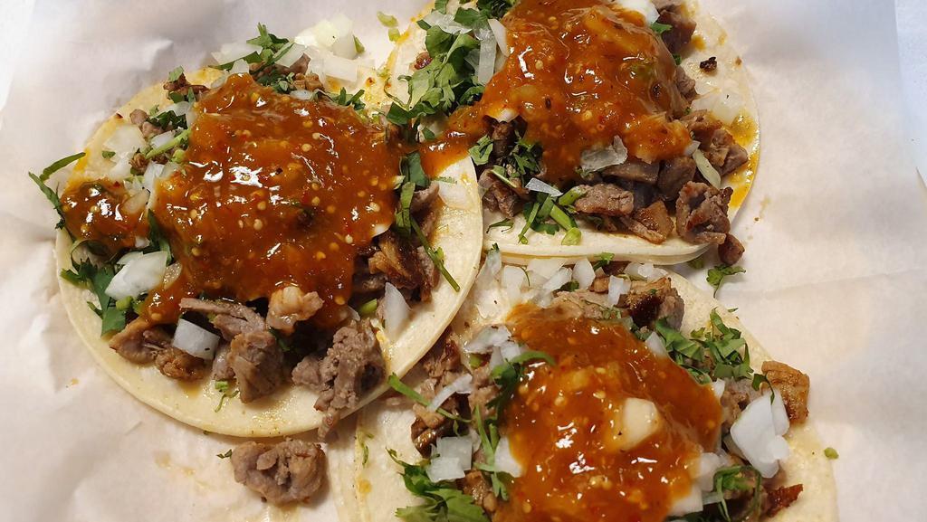 Taco · Choice of meat, onion, and cilantro.