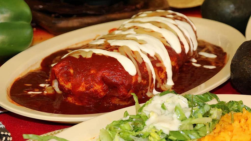 Burrito Mojado · Super burrito, topped with enchilada sauce and melted cheese.