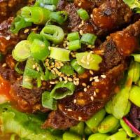 Vegan Beyond Meat Rice Bowl · Vegan Beyond Meat patty with Red Sauce, Green Onions, Edamame, Served on Furikake and Season...