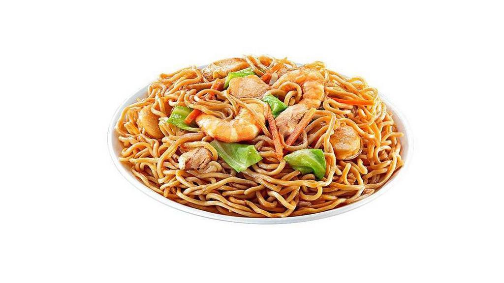 Pancit Canton · Stir fried noodles with a sweet-salty soy-based sauce, topped with succulent fish balls slices, chicken slices, shrimp, crisp carrots, cabbage and garnished with fried onions