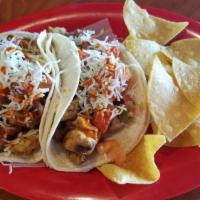 Crispy Taco Salad · Fresh romaine lettuce topped with black beans, shredded cheese, Salsa Fresca and guacamole s...