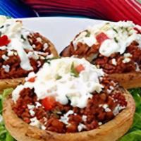 SOPES (2pcs) · Two thick corn masa tortillas topped with meat, refried beans, lettuce, sour cream, cheese a...