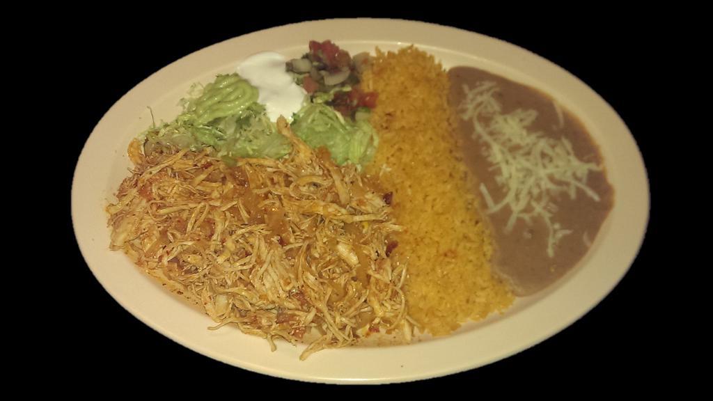 SHREDDED CHICKEN PLATE · Shredded chicken served with rice, refried beans topped with cheese, sour cream, guacamole, salsa and tortillas.