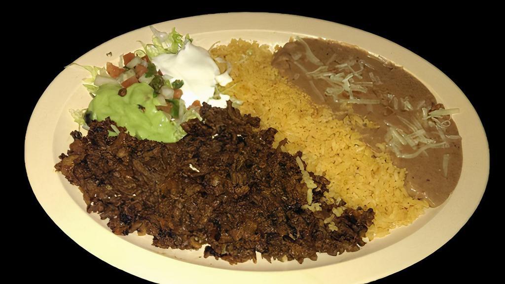 AL PASTOR PLATE · Marinated pork  served with rice, refried beans topped with cheese, sour cream, guacamole, salsa and tortillas.