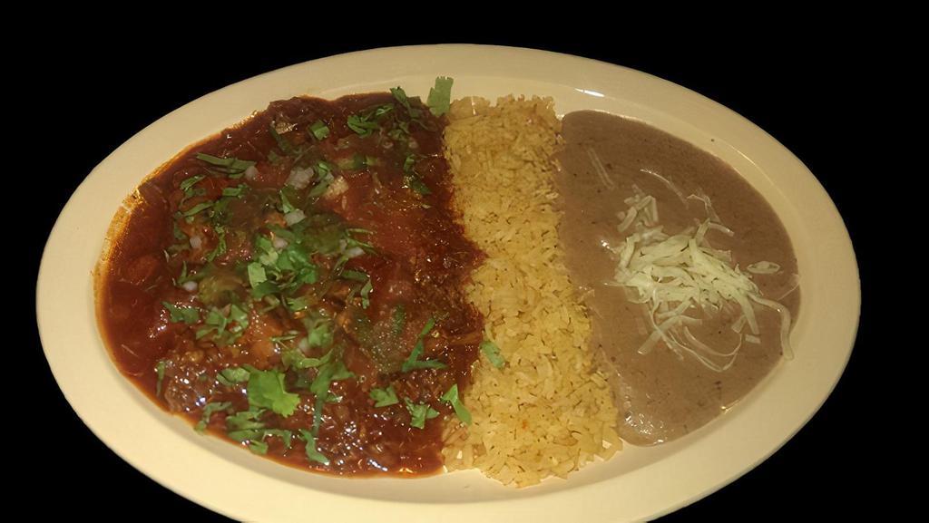 BIRRIA · Beef stew topped with onions, cilantro, and salsa.