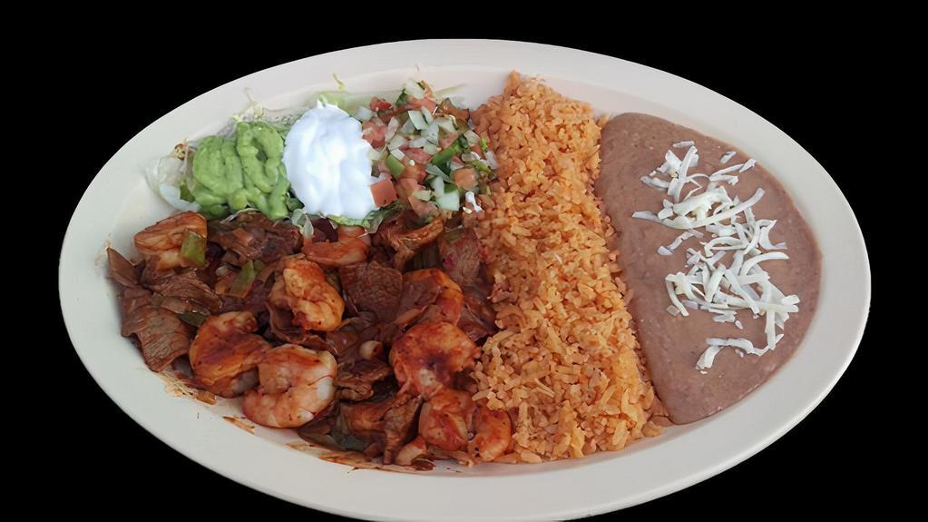 MAR Y TIERRA · Surf & Turf Shrimp and steak sautéed with onions in a homemade style sauce.  Served with rice, refried beans topped with cheese, sour cream, guacamole, salsa and tortillas.