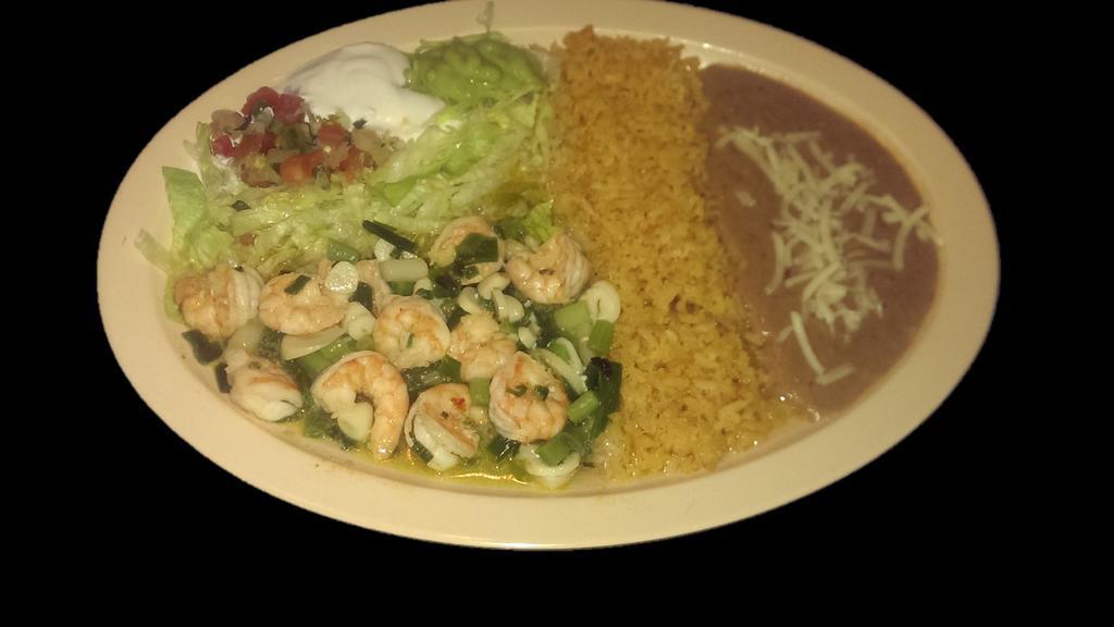 GARLIC SHRIMP  · Shrimp sautéed with garlic and onions.  Served with rice, refried beans topped with cheese, sour cream, guacamole, salsa and tortillas.