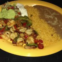 SHRIMP FAJITAS · Shrimp grilled with peppers, onions and tomatoes. Served with rice, refried beans, sour crea...