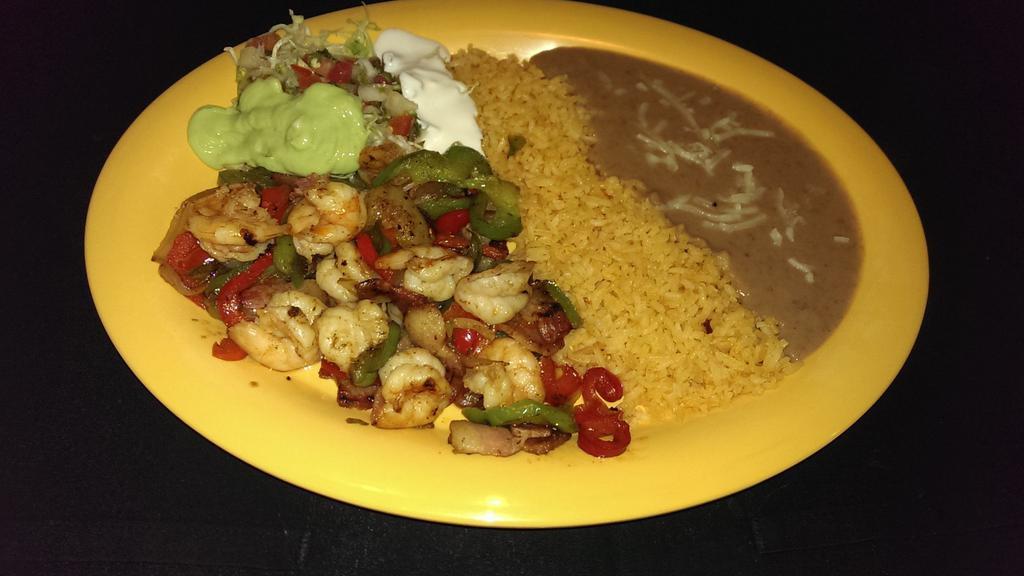 SHRIMP FAJITAS · Shrimp grilled with peppers, onions and tomatoes. Served with rice, refried beans, sour cream, cheese, lettuce, guacamole, salsa and corn tortillas.
