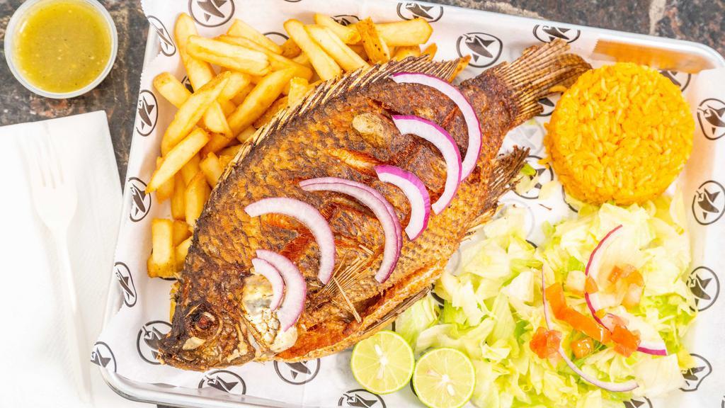 Mojarra (Fried Tilapia) · Tilapia whole fish topped with sautéed vegetables.