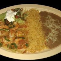 SHRIMP RANCHEROS · Shrimp sauteed with green peppers, onions, and tomatoes. Served with rice, refried beans top...
