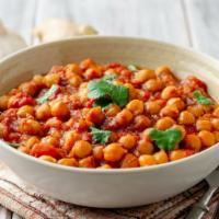 Vegan Chana Masala · Freshly cooked garbanzo beans mixed in with herbs and classic indian spices.