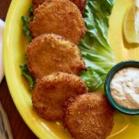 Fried Green Tomatoes · Six slices of tomatoes, hand battered and deep fried. Served with a side of creamy rémoulade...