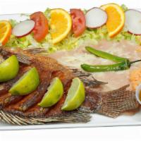 Mojarra Frita · fried mojarra fish with, salad, rice & beans