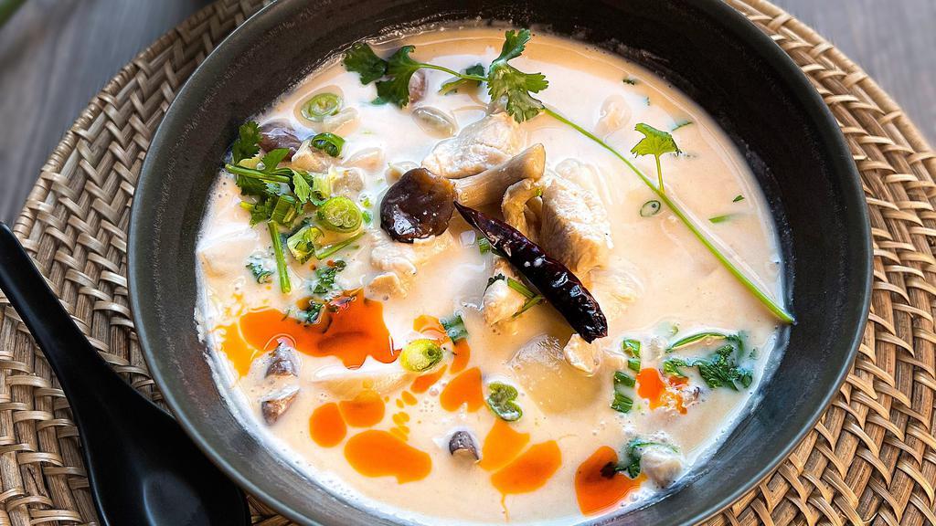 Tom Kha  · Lemongrass, galangal, kaffir lime leaves, cilantro, oyster mushrooms, cherry tomatoes, green onions and onions in a savory coconut milk broth.