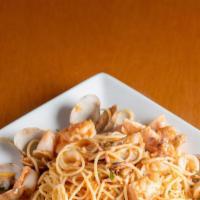 Pasta Pescatora · Spaghetti with seafood, salmon, prawns, calamari, cams in a light tomatoes sauce
