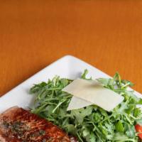 New York Steak grilled · Olive oil herbs sauce with arugula salad Parmigiano cheese.