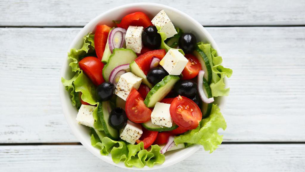 The Greek Salad · Crisp romaine hearts, fresh cucumbers, tomatoes and red onions with tang feta cheese, Kalamata olives and house lemon juice and olive oil dressing.