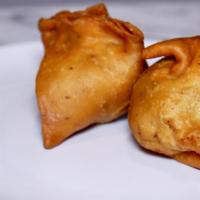 A01. Vegetable Samosa · Vegetarian turnovers stuffed with potatoes, peas, spices and served with tamarind chutney.