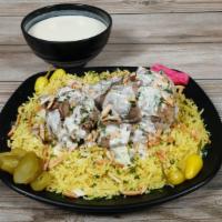 Mansaf · Lamb cooked in a sauce of fermented dried yogurt and served with rice.