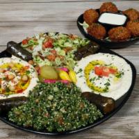 Falafel Veggie platter · 6 falafel balls, 3 grape leaves, hummus, mutabbal, tabbouleh, house salad, tahini sauce, pic...