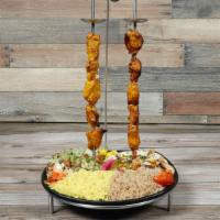 Chicken Kabob plate · 2 skewers over seasoned rice served with house salad, hummus and pita bread.