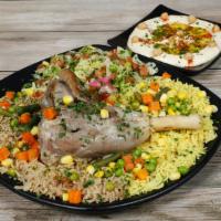 Lamb shank plate · Served with rice, house salad, hummus and pita bread.