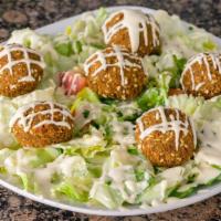 6 Falafel Balls Over House Salad · lettuce, tomatoes, cucumber, parsley, topped with feta cheese, falafel, and tahini sauce.