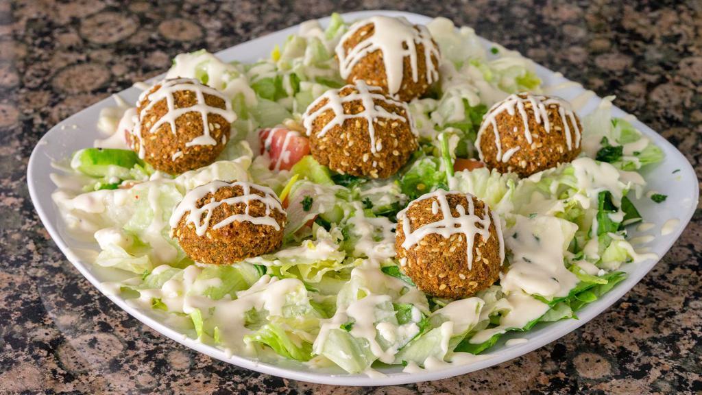 6 Falafel Balls Over House Salad · lettuce, tomatoes, cucumber, parsley, topped with feta cheese, falafel, and tahini sauce.