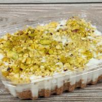 Aish Elsraya · syrup soaked breadcrumbs topped with luscious and rose-flavored milk pudding and pistachios.