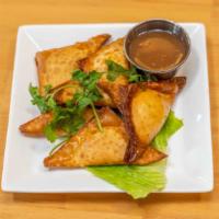 Dungeness Crab Puffs · Dungeness crab meat with onion and herb cheese wrapped in a crispy wonton shell. Served with...