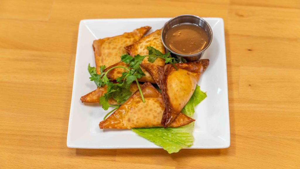 Dungeness Crab Puffs · Dungeness crab meat with onion and herb cheese wrapped in a crispy wonton shell. Served with homemade plum sauce.