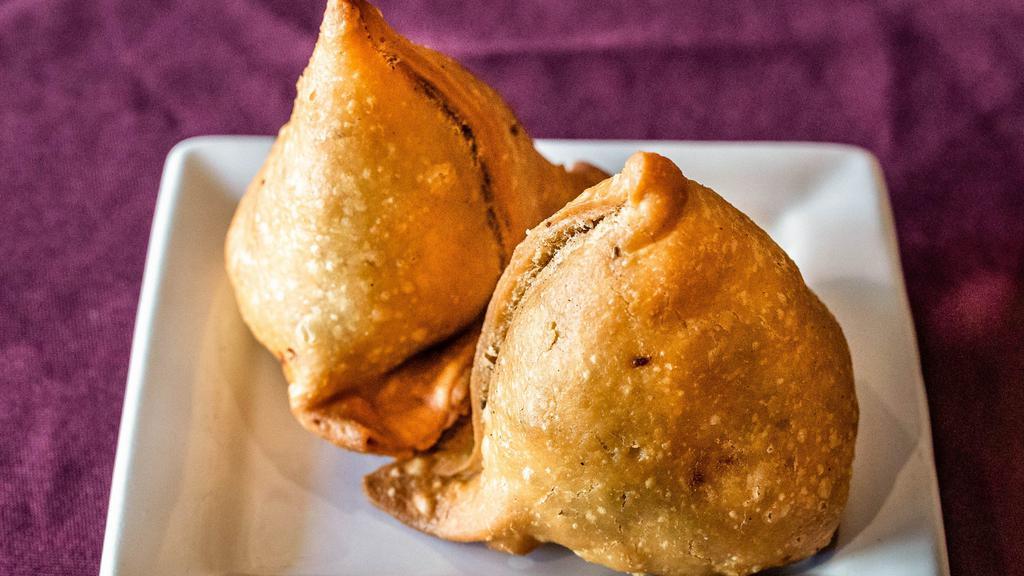 Vegetable Samosa · Vegetarian turnovers stuffed with potatoes, peas, spices, and served with tamarind chutney.