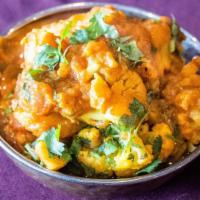 Aloo Gobi · Vegetarian. Cauliflower, potatoes, tomatoes, ginger, coriander, turmeric, and cumin.