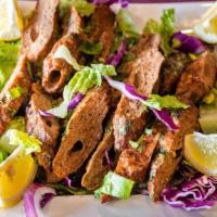 Lamb Seekh Kebab · Ground lamb marinated in spices and cooked on skewers in a clay oven.
