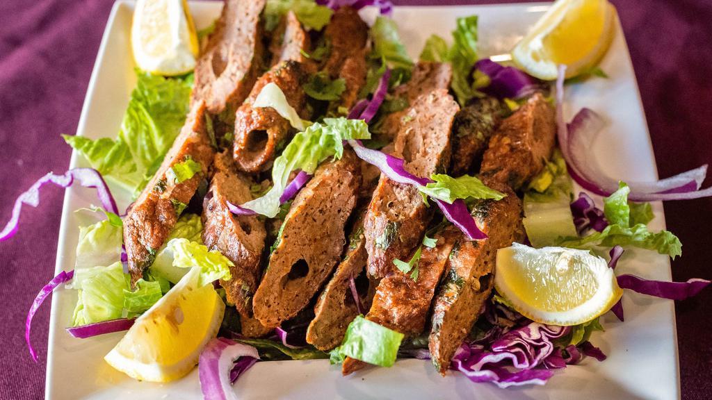 Lamb Seekh Kebab · Ground lamb marinated in spices and cooked on skewers in a clay oven.