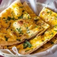 Garlic Naan · Fresh bread cooked in a clay oven topped with minced garlic and cilantro.