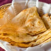 Cheese Naan · Fresh bread cooked in a clay oven and topped with cheese.