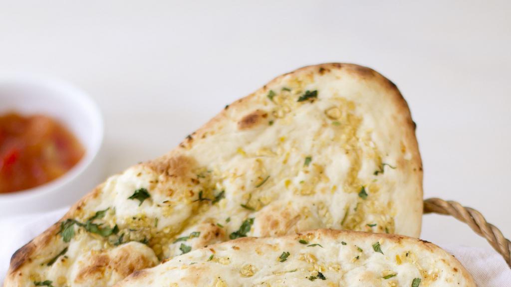 Garlic Naan · Indian yeast-leavened bread, traditionally baked in clay oven with chopped garlic on top.