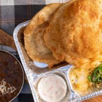 Chana Bhatura · Two pieces. Fluffy deep-fried leavened bread served with chickpea curry. Eight oz.