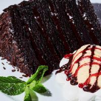 Chocolate Cake A La Mode · Warm, gooey chocolate cake served with vanilla ice cream topped with chocolate and raspberry...