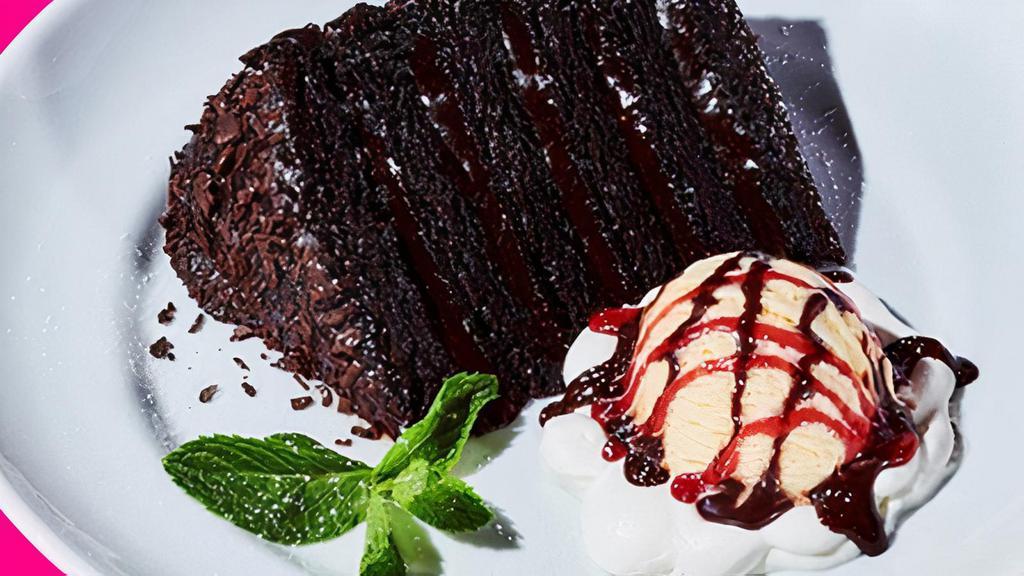 Chocolate Cake A La Mode · Warm, gooey chocolate cake served with vanilla ice cream topped with chocolate and raspberry topping.